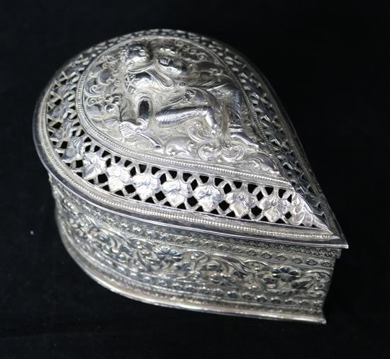 A Burmese silver teardrop shaped box with pierced cover containing minor items of jewellery.